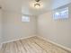 Bright basement space featuring wood-look floors and natural light from basement windows at 1731 Uinta St, Denver, CO 80220