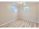 Finished basement space featuring wood-look floors and natural light from the windows at 1731 Uinta St, Denver, CO 80220