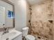 Bathroom featuring tiled shower, toilet, and sink at 1731 Uinta St, Denver, CO 80220