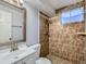 Bathroom featuring shower, neutral paint palette, and large vanity at 1731 Uinta St, Denver, CO 80220