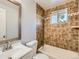 Bathroom featuring shower over tub, window and neutral color palette at 1731 Uinta St, Denver, CO 80220