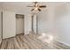Neutral bedroom with gray plank flooring, ceiling fan, and ample closet space at 1731 Uinta St, Denver, CO 80220