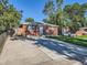 A charming brick home featuring a wide driveway, well-maintained lawn, and a secure wooden fence at 1731 Uinta St, Denver, CO 80220