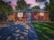 Charming brick home with a well-manicured lawn, concrete driveway, and inviting front entrance at 1731 Uinta St, Denver, CO 80220