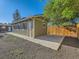 Detached garage with concrete parking pad, ample windows, and convenient access at 1731 Uinta St, Denver, CO 80220