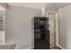 Modern black refrigerator situated near the kitchen entrance, offering a glimpse of bright, updated kitchen at 1731 Uinta St, Denver, CO 80220