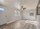 Bright living room with wood-look floors, a ceiling fan, and natural light from windows at 1731 Uinta St, Denver, CO 80220
