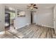 Open-concept living space featuring wood-look floors, a ceiling fan, and a view into the kitchen at 1731 Uinta St, Denver, CO 80220