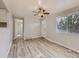 Bright living room features stylish gray plank flooring, ceiling fan, and great natural light from the window at 1731 Uinta St, Denver, CO 80220