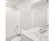 Clean bathroom with shower and tub combo, sleek vanity, and large mirror at 6068 Hourglass Dr, Brighton, CO 80601
