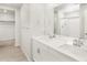 Bright bathroom featuring a double sink vanity with white countertops and modern fixtures at 6068 Hourglass Dr, Brighton, CO 80601