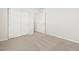 This is a bedroom with carpeted floors, two closets, and neutral paint at 6068 Hourglass Dr, Brighton, CO 80601
