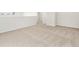 Hallway area featuring plush neutral carpeting and white walls, offering a bright and spacious feel at 6068 Hourglass Dr, Brighton, CO 80601