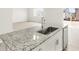 Close up of kitchen island sink and stainless steel dishwasher in an open floorplan concept at 6068 Hourglass Dr, Brighton, CO 80601