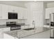 Modern kitchen with granite countertops, stainless steel appliances, a stylish faucet, and ample cabinet space at 6068 Hourglass Dr, Brighton, CO 80601