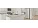 Modern kitchen with granite counters, stainless steel appliances, an island with a sink, and plenty of cabinet space at 6068 Hourglass Dr, Brighton, CO 80601