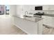 Bright kitchen featuring a large island with granite countertops, stainless steel appliances, and white cabinetry at 6068 Hourglass Dr, Brighton, CO 80601