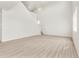 Spacious living room with staircase and lots of natural light with white walls and floors at 6068 Hourglass Dr, Brighton, CO 80601