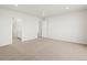 Bright main bedroom with neutral carpet, white walls, and ample natural light from a large window at 6068 Hourglass Dr, Brighton, CO 80601