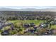 This aerial showcases a vibrant residential area with green spaces and mountain views at 12734 Eudora Dr, Thornton, CO 80241