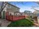 Exterior view of the back of the home with a deck, yard and shed at 12734 Eudora Dr, Thornton, CO 80241