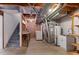 Unfinished basement with open ceiling, washer/dryer hookups, and utility sink at 12734 Eudora Dr, Thornton, CO 80241