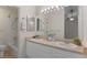 Bathroom with dual sinks, granite countertop, updated fixtures, and a shower-tub combo at 12734 Eudora Dr, Thornton, CO 80241