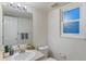 Cozy bathroom featuring a vanity, toilet, and window with privacy glass at 12734 Eudora Dr, Thornton, CO 80241
