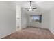 Bedroom showcasing neutral carpet, a large window, and a doorway to an attached closet at 12734 Eudora Dr, Thornton, CO 80241