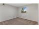 Cozy bedroom with neutral carpet, a window, and a built-in shelf at 12734 Eudora Dr, Thornton, CO 80241