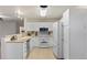 Bright kitchen featuring white cabinets, modern appliances, and neutral countertops at 12734 Eudora Dr, Thornton, CO 80241
