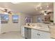Kitchen area with stainless steel dishwasher, sink, light countertops, and windows at 12734 Eudora Dr, Thornton, CO 80241