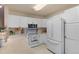 Well-lit kitchen with white cabinetry, a microwave, and a large white refrigerator at 12734 Eudora Dr, Thornton, CO 80241