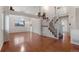 Hardwood floors, neutral decor, and ample natural light fill this living and dining area at 12734 Eudora Dr, Thornton, CO 80241