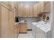 Functional laundry room features ample cabinetry, modern washer/dryer, and a clean design at 18496 Pixie Park Rd, Monument, CO 80132