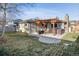 A cozy backyard featuring a patio, pergola, and a relaxing hot tub at 13215 Peacock Dr, Lone Tree, CO 80124