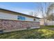 Backyard view with grass, brickwork, siding and two windows at 13215 Peacock Dr, Lone Tree, CO 80124