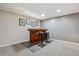 Finished basement features a classic wooden bar and pub stools for casual entertaining at 13215 Peacock Dr, Lone Tree, CO 80124