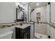 Elegant bathroom featuring marble tiling in the walk-in shower, and a dark wood vanity with modern fixtures at 13215 Peacock Dr, Lone Tree, CO 80124