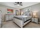 Well-lit bedroom showcasing a full suite with a bed frame, dresser, and nightstands in a matching whitewash finish at 13215 Peacock Dr, Lone Tree, CO 80124