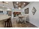 Open-concept dining area showcases hardwood floors, a decorative ceiling and a modern white table with seating for four at 13215 Peacock Dr, Lone Tree, CO 80124