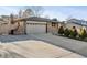 Brick home boasting a long driveway and tidy front yard with small, sculpted trees at 13215 Peacock Dr, Lone Tree, CO 80124