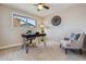 Bright office area featuring an industrial style desk, chair, and a window with natural light at 13215 Peacock Dr, Lone Tree, CO 80124