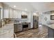 Well-lit kitchen featuring stainless steel appliances and wood-look floors at 13215 Peacock Dr, Lone Tree, CO 80124