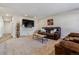 Comfortable living room features a wall-mounted TV, modern coffee table, and cozy brown leather furniture at 13215 Peacock Dr, Lone Tree, CO 80124