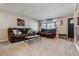 Spacious living room with comfortable seating, a large window, and neutral color palette at 13215 Peacock Dr, Lone Tree, CO 80124