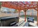 View of the covered hot tub and seating under the wooden pergola in backyard at 13215 Peacock Dr, Lone Tree, CO 80124