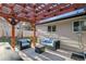 Cozy outdoor seating area under a wooden pergola with hot tub at 13215 Peacock Dr, Lone Tree, CO 80124