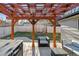 Cozy outdoor seating area under a wooden pergola in a well-maintained backyard at 13215 Peacock Dr, Lone Tree, CO 80124