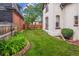 A well-maintained backyard with a lush lawn, privacy fence, and garden bed provides a serene outdoor space at 912 S Washington St, Denver, CO 80209